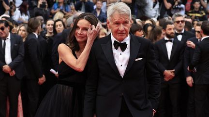 Sur le tapis rouge, Harrison Ford est apparu d'abord jeudi soir au bras de son épouse, l'actrice américaine Calista Flockhart, connue pour son rôle dans la série "Ally McBeal". (VALERY HACHE / AFP)