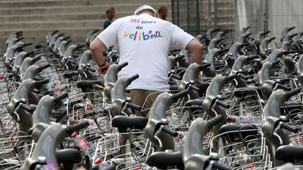 Un cycliste parmi les Vélibs, les vélos en libre-service de Paris, en 2008.&nbsp; (THOMAS COEX / AFP)