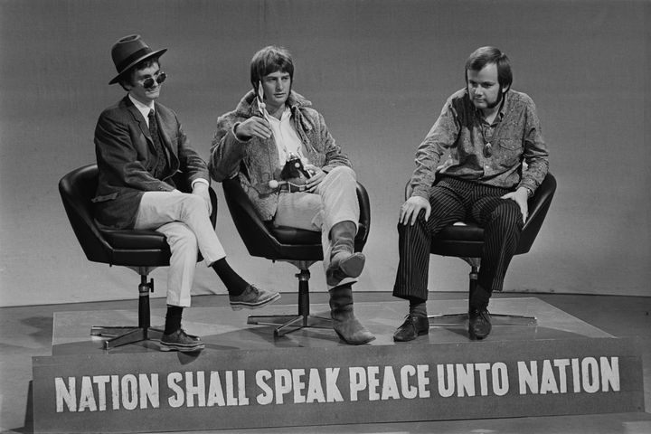 Le DJ Kenny Everett, Emperor Rosko (Michael Joseph Pasternak) et John Peel sur une scène arborant la devise de la BBC "La nation doit parler de paix à la nation" avant le lancement de la BBC Station 'Radio 1', le 12 septembre 1967. (LARRY ELLIS / HULTON ARCHIVE)