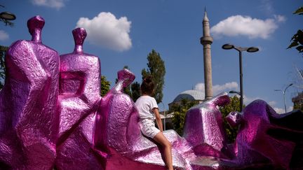 Une jeune Kosovare de Pristina s'est appropriée une installation de la biennale d'art contemporain Manifesta, le 15 août 2022. (ARMEND NIMANI / AFP)