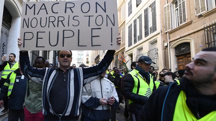 A Marseille, ce manifestant brandit une pancarte "Macron, nourris ton peuple". (BORIS HORVAT / AFP)