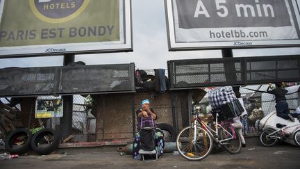 Une femme est assise à l'entrée du campement rom de Bobigny (Saint-Denis), le 21 juillet 2015. (MARTIN BUREAU / AFP)