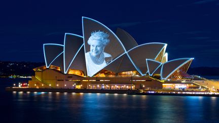 Les voiles de&nbsp;béton de&nbsp;l'opéra de Sydney (Australie)&nbsp;se sont illuminées&nbsp;le 9 septembre 2022 en hommage à la monarque décédée. (ROBERT WALLACE / AFP)