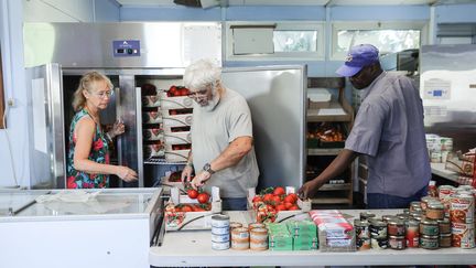 Des bénévoles distribuent des denrées alimentaires à Grigny (Essonne) le 6 septembre 2023. (TERESA SUAREZ / MAXPPP)