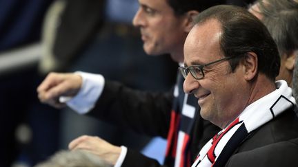 François Hollande sourit dans les tribunes du match entre la France et la Roumanie, le 10 juin 2016, en ouverture de l'Euro 2016, au Stade de France.&nbsp; (MIGUEL MEDINA / AFP)