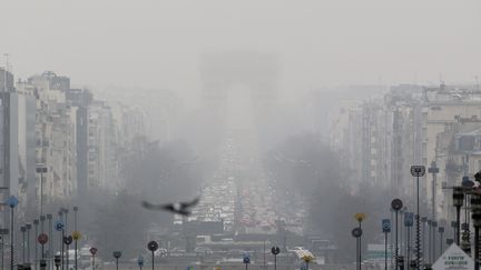 L'Arc de Triomphe perdu dans la brume de pollution qui flotte au-dessus de Paris, le 20 mars 2015. (  MAXPPP)