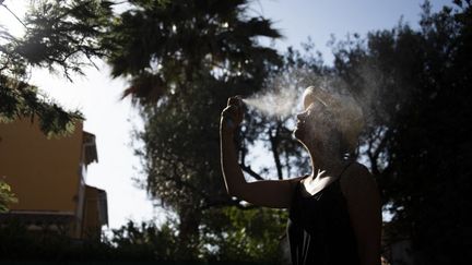 A person cools off with water, in Hyères (Var), July 9, 2023. (MAGALI COHEN / HANS LUCAS / AFP)