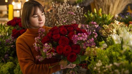 Une fleuriste tient un bouquet de roses rouges, le 11 février 2021, à Nantes. (MAXPPP)