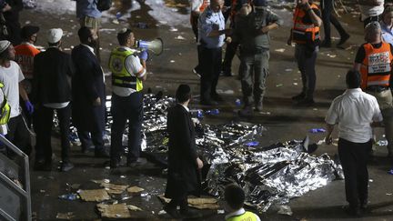 Des secouristes se tiennent autour de dépouilles de pèlerins morts dans un mouvement de foule, le&nbsp;30 avril 2021, au mont Méron (Israël). (DAVID COHEN / JINI PIX / AFP)