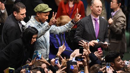 Pharrell Williams sera le directeur artistique d'un grand concert pour le climat à Paris à l'automne. Sur la photo, il est à New York, à l'Onu, à la journée internationale du bonheur (20 mars 2015)
 (Timothy A. Clary / AFP)