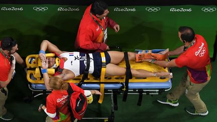 Le gymnaste français Samir Aït Saïd évacué sur une civière, après une chute, lors des qualifications au saut, pour les JO de Rio, le 6 août 2016. (ANTONIN THUILLIER / AFP)