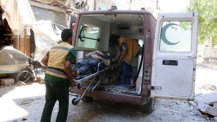 Des ambulanciers évacuent un blessé après une frappe aérienne à Alep, dans le nord de la Syrie, le 16 juillet 2016. (THAER MOHAMMED / AFP)