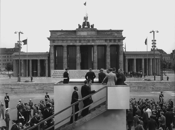 Le pr&eacute;sident Kennedy (de dos, au centre), face &agrave; la porte de Brandebourg, &agrave; Berlin (Allemagne), le 26 juin 1963. (DPA / AFP)