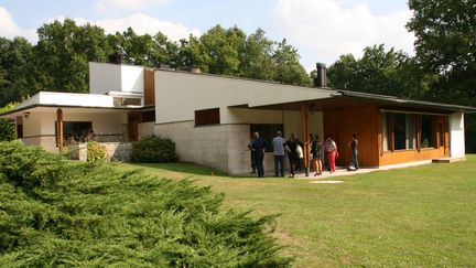 "La Maison Louis Carré" construite par Alvar Alto à Bazoche-sur Guyonne ( 40km de Paris) est située sur une colline. On accède à la maison par le bas du terrain, qui offre une vue oblique sur la façade d'entrée tournée vers le nord-ouest. De ce côté ci, la pente du toit suit le mouvement du paysage.
 (Sophie Jouve/Culturebox)