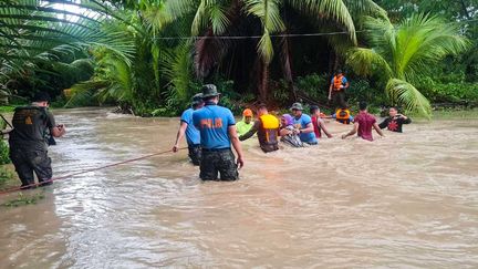 Des sauveteurs aident des résidents de Kalamansig, aux Philippines, le 28 octobre 2022.&nbsp; (HANDOUT / REGIONAL MARITIME UNIT 12 - SULT / AFP)