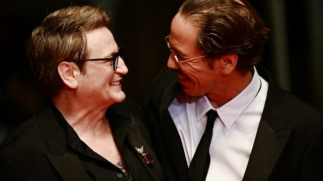 Actors Benoît Magimel and Reda Kateb, regulars at the Cannes Film Festival, give each other a knowing look before climbing the 24 steps of the Palais des Festivals to attend the screening of the film "Omar The Strawberry" in which they play two bandit friends in Algeria.  (LOIC VENANCE / AFP)