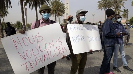 Manifestation à Dakar pour la réouverture des lieux culturels et des bars, fermés en raison de l'épidémie de Covid-19. De nombreux étudiants font des petits boulots pour financer leurs études. (SEYLLOU / AFP)