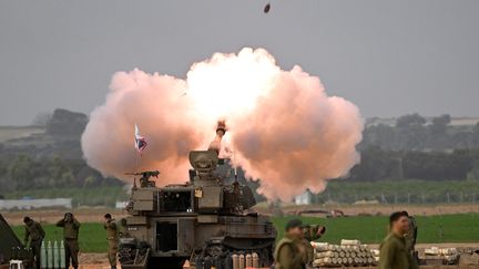 An Israeli tank fires a projectile towards the Gaza Strip, December 10, 2023, in Nahal Oz (Israel).  (MOSTAFA ALKHAROUF / ANADOLU / AFP)