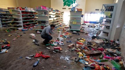 Un homme constate les d&eacute;g&acirc;ts apr&egrave;s le saccage d'un magasin, le 9 d&eacute;cembre 2013, &agrave; Tucuman, dans le nord de l'Argentine.&nbsp; (WALTER MONTEROS / AFP)