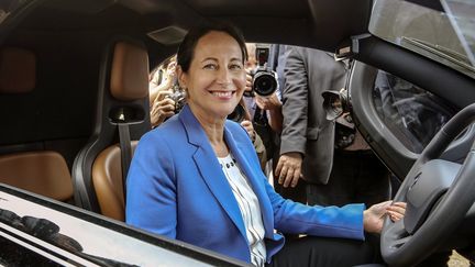 La ministre de l'Ecologie, S&eacute;gol&egrave;ne Royal, essaie une voiture &eacute;lectrique lors d'une conf&eacute;rence sur l'environnement &agrave; Lyon (Rh&ocirc;ne), le 15 octobre 2014. (PHILIPPE MERLE / AFP)