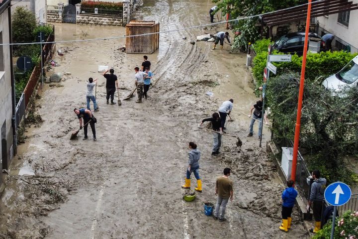 Residents of Cesena clean up the mud after heavy rains in northern Italy on May 18, 2023. (ALESSANDRO SERRANO / AFP)