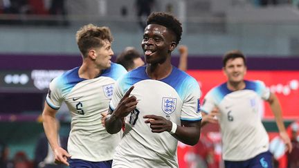 Bukayo Saka célèbre son premier but contre l'Iran, le 21 novembre 2022 à Doha. (ADRIAN DENNIS / AFP)