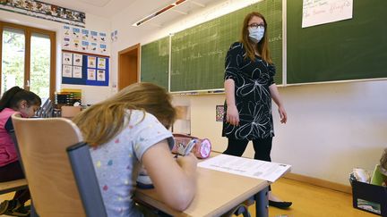 Une enseignante donne une leçon à des élèves de primaire à Strasbourg, le 22 juin 2020 (photo d'illustration). (FREDERICK FLORIN / AFP)