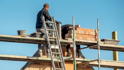 Un travailleur du BTP sur un échafaudage, le 28 septembre 2015 à Godewaersvelde, dans le Nord. (PHILIPPE HUGUEN / AFP)