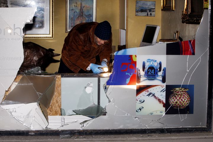 Un policier enquête sur le vol d'une lithographie d'Edvard Munch, le 12 novembre 2009, dans la galerie&nbsp;Nyborg Kunst d'Oslo (Norvège). (LISE AASERUD / SCANPIX NORWAY / AFP)