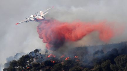 Trois Canadair se relaient en permanence pour tenter de maîtriser l'incendie qui s'est déclaré à Rognac (Bouches-du-Rhône).&nbsp; (BORIS HORVAT / AFP)