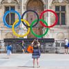 Des touristes devant les anneaux olympiques sur le parvis de l'Hôtel de ville à Paris, le 19 juillet 2023. (LEYLA VIDAL / MAXPPP)