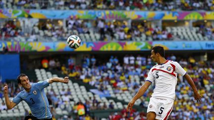 L'Uruguayen Diego Godin (G) face au Costaricain Celso Borges lors d'un match de Coupe du monde disput&eacute; &agrave; Fortaleza (Br&eacute;sil) le&nbsp;samedi 14 juin 2014. (MARCELO DEL POZO / REUTERS)