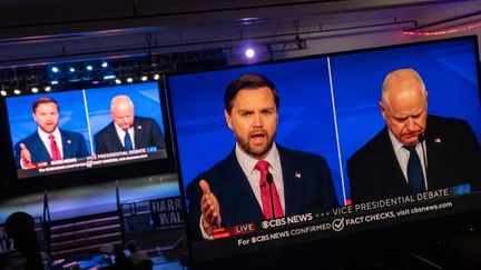 Un écran diffuse le débat des colistiers sur CBS News entre le candidat républicain à la vice-présidence, J.D. Vance, et son rival démocrate, Tim Walz, à Harrisburg, en Pennsylvanie, le 1er octobre 2024. (NATHAN MORRIS / NURPHOTO / AFP)