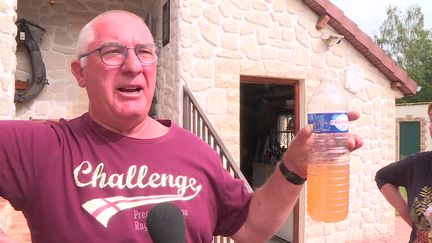 Patrick Labassé présente l'eau qui voulait à son robinet le 5 septembre. (FTV)