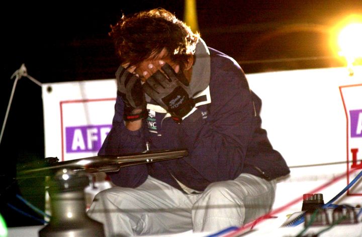 Alain Gautier se prend la t&ecirc;te entre les mains &agrave;&nbsp;son arriv&eacute;e &agrave; la Solitaire du Figaro,&nbsp;dans la nuit du 21 au 22 ao&ucirc;t 2003,&nbsp;&agrave; Saint-Nazaire, 13 secondes derri&egrave;re Armel Le Cl&eacute;ac'h. (NATACHA FAVREAU / AFP)