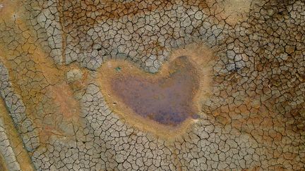 Une flaque en forme de cœur subsiste à l'emplacement du lac Paraquequara, à Manaus, au Brésil, le 6 octobre 2023. (MICHAEL DANTAS / AFP)