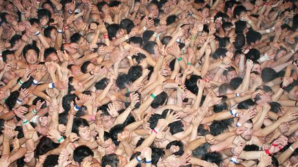 Des fid&egrave;les uniquement v&ecirc;tus de pagnes essaient d'attraper des b&acirc;tons jet&eacute;s par des pr&ecirc;tres lors de la traditionnelle f&ecirc;te de l'Homme nu &agrave; Okayama (Japon), le 18 f&eacute;vrier 2012. (KYODO / REUTERS)