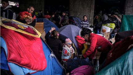 Des demandeurs d'asile albanais sont &eacute;vacu&eacute;s de leur campement &agrave; Lyon (Rh&ocirc;ne), avant d'&ecirc;tre relog&eacute;s, le 18 novembre 2013. (JEFF PACHOUD / AFP)