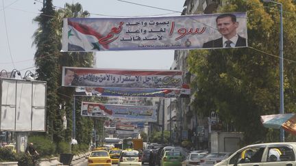 Des pancartes &agrave; l'effigie du pr&eacute;sident syrien Bachar Al-Assad, dans les rues de Lattaqui&eacute; (Syrie), le 24 mai 2014. ( KHALED AL HARIRI / REUTERS)