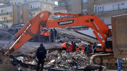 Des sauveteurs cherchent des victimes dans les décombres d'immeubles effondrés à Gaziantep, en Turquie, le 7 février 2023.&nbsp; (ZEIN AL RIFAI / AFP)