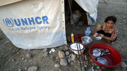 Une jeune r&eacute;fugi&eacute;e syrienne-kurde dans le camp de&nbsp;Quru Gusik, pr&egrave;s d'Arbil, capitale de la r&eacute;gion autonome du Kurdistan, dans le nord de l'Irak, le 22 ao&ucirc;t 2013. (SAFIN HAMED / AFP)