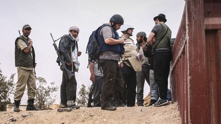 Steven Sotloff (casqu&eacute;, au centre), le journaliste am&eacute;ricain d&eacute;capit&eacute; par l'Etat islamique le 2 septembre 2014, photographi&eacute; ici en Libye, en juin 2011. (ETIENNE DE MALGLAIVE / AFP)