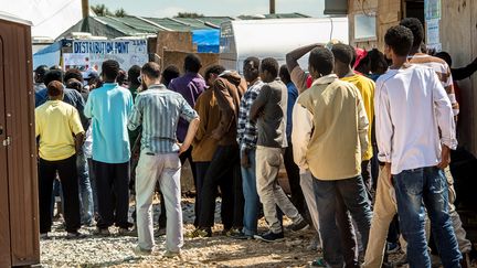 Des migrants dans la "jungle" &agrave; Calais font la queue pour une distribution de nourriture, le 24 juillet 2016.&nbsp; (PHILIPPE HUGUEN / AFP)