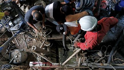 Des pompiers et des secouristes recherchent des mineurs coincés dans une mine d'or à Neira (Colombie), le 27 mars 2021. (JOHN BONILLA / AFP)