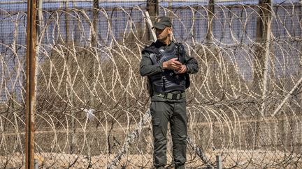 Un membre des forces de sécurité marocaines face au mur de barbelés à l'enclave espagnole de Melilla au Maroc, le 26 juin 2022. (FADEL SENNA / AFP)