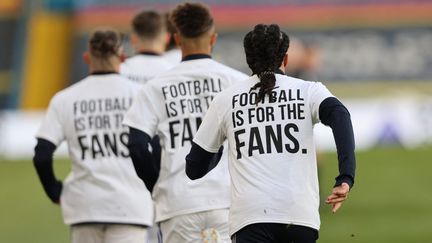 Durant l'échauffement avant le début de la rencontre face à Liverpool le 19 avril 2021, les joueurs de Leeds ont arboré un message clair sur leur tee-shirt : "Le football est pour les fans". (CLIVE BRUNSKILL / POOL)