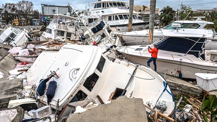 Des bateaux détruits dans un port de plaisance, à Fort Myers, en Floride (Etats-Unis), après le passage de l'ouragan Ian, le 29 septembre 2022. (GIORGIO VIERA / AFP)