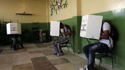 Des &eacute;lecteurs votent dans un bureau de Quito (Equateur) pour &eacute;lire leur pr&eacute;sident, le 17 f&eacute;vrier 2013. (DOLORES OCHOA / AP / SIPA)