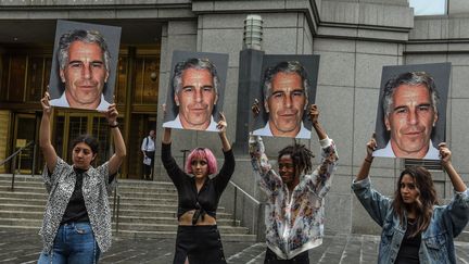 Des manifestants brandissent des portraits de Jeffrey Epstein, le 8 juillet 2019, devant le tribunal de New York.&nbsp; (STEPHANIE KEITH / GETTY IMAGES NORTH AMERICA / AFP)