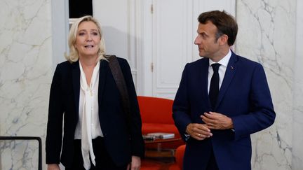 Marine Le Pen aux côtés d'Emmanuel Macron après des entretiens à l'Elysée, le 21 juin 2022, deux jours après les législatives. (LUDOVIC MARIN / AFP)